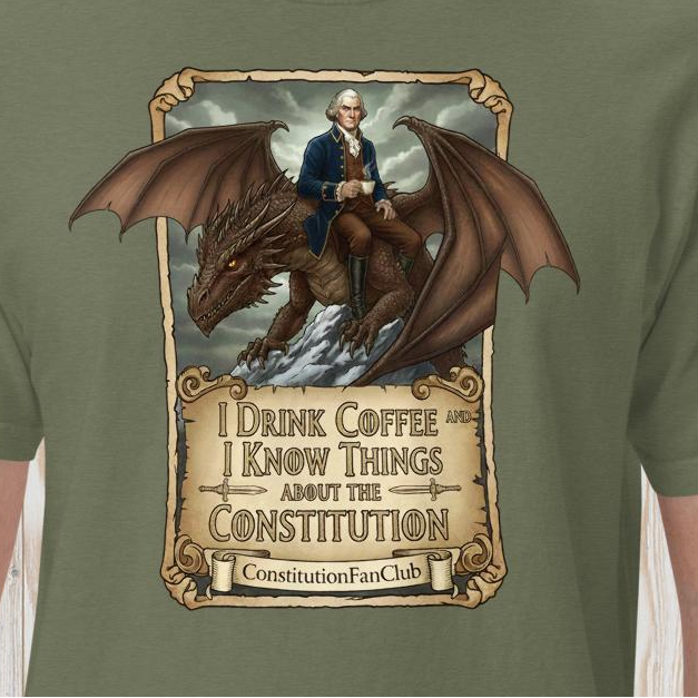 An olive green t-shirt featuring a large graphic print of a man in a blue coat riding a brown dragon, with a parchment-style banner below reading 'I Drink Coffee and I Know Things About the Constitution' and 'ConstitutionFanClub'.
