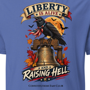 A close-up of a blue graphic t-shirt featuring a raven perched on a Liberty Bell with autumn leaves, a full moon, and banners reading 'LIBERTY IS ALIVE' and 'AND RAISING HELL.' The text 'CONSTITUTION FAN CLUB' is printed below.